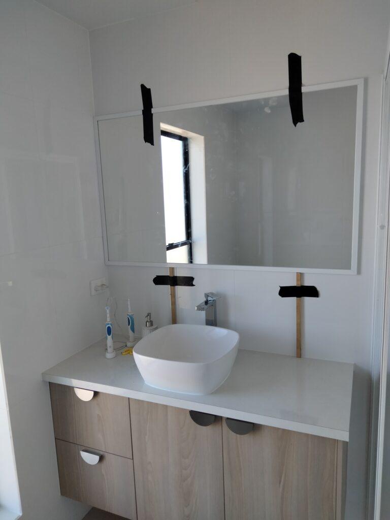 White framed bathroom mirror installation Seaforth QLD